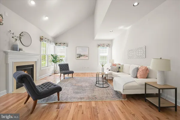 a living room with furniture a fireplace and a table