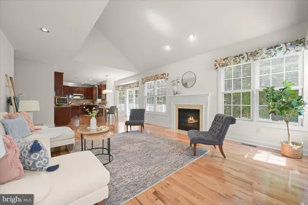 a living room with furniture a fireplace and a table