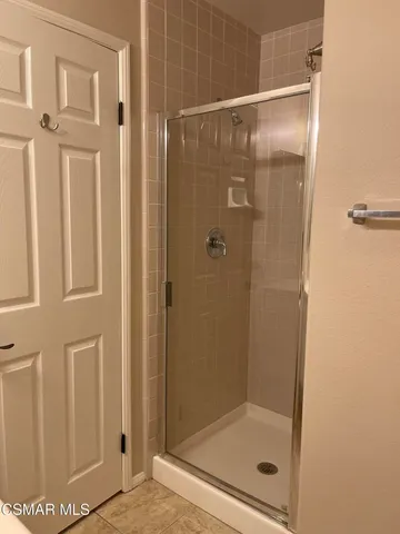 a bathroom with a glass shower door