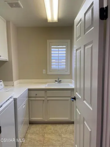 a view wooden cabinets a sink and dishwasher in a room