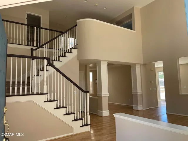 a view of staircase with railing and white walls
