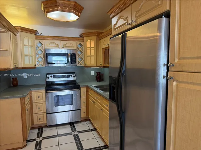 a kitchen with stainless steel appliances a refrigerator and a stove