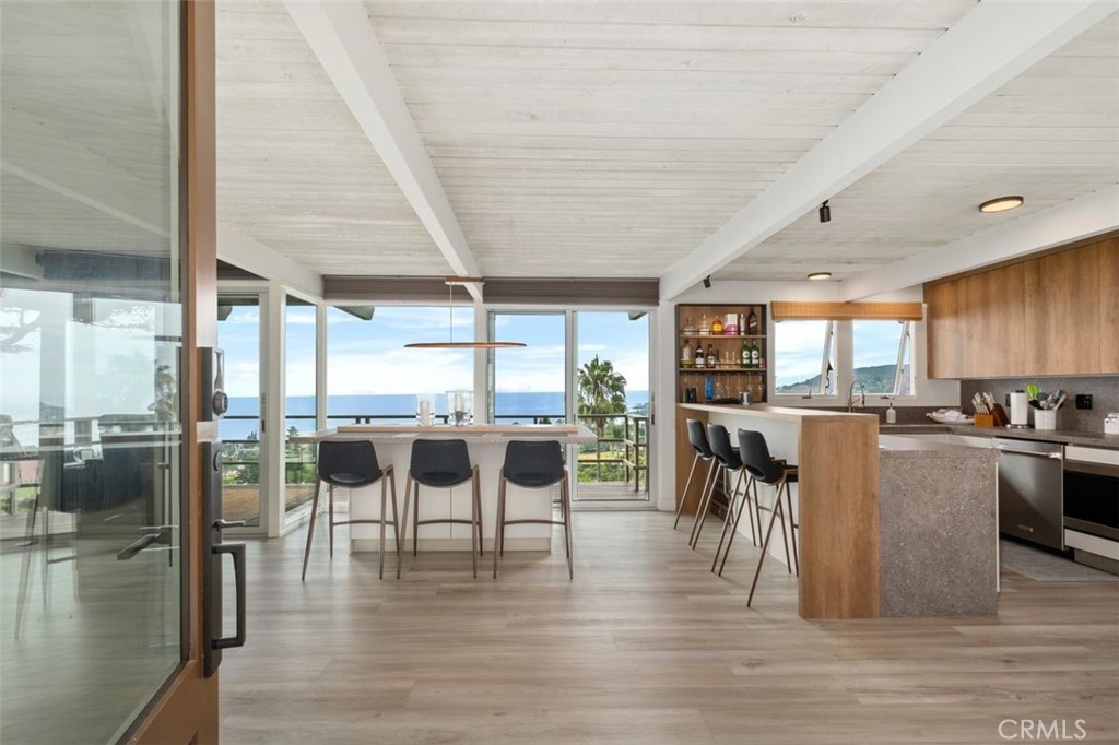 945 Coast View Drive Laguna Beach, CA 92651 - Photo 11 of 40 a dining room with furniture and wooden floor