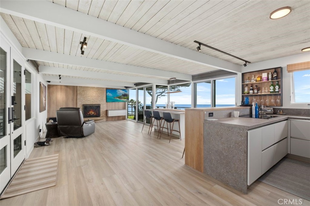 945 Coast View Drive Laguna Beach, CA 92651 - Photo 12 of 40 a living room with furniture and a flat screen tv