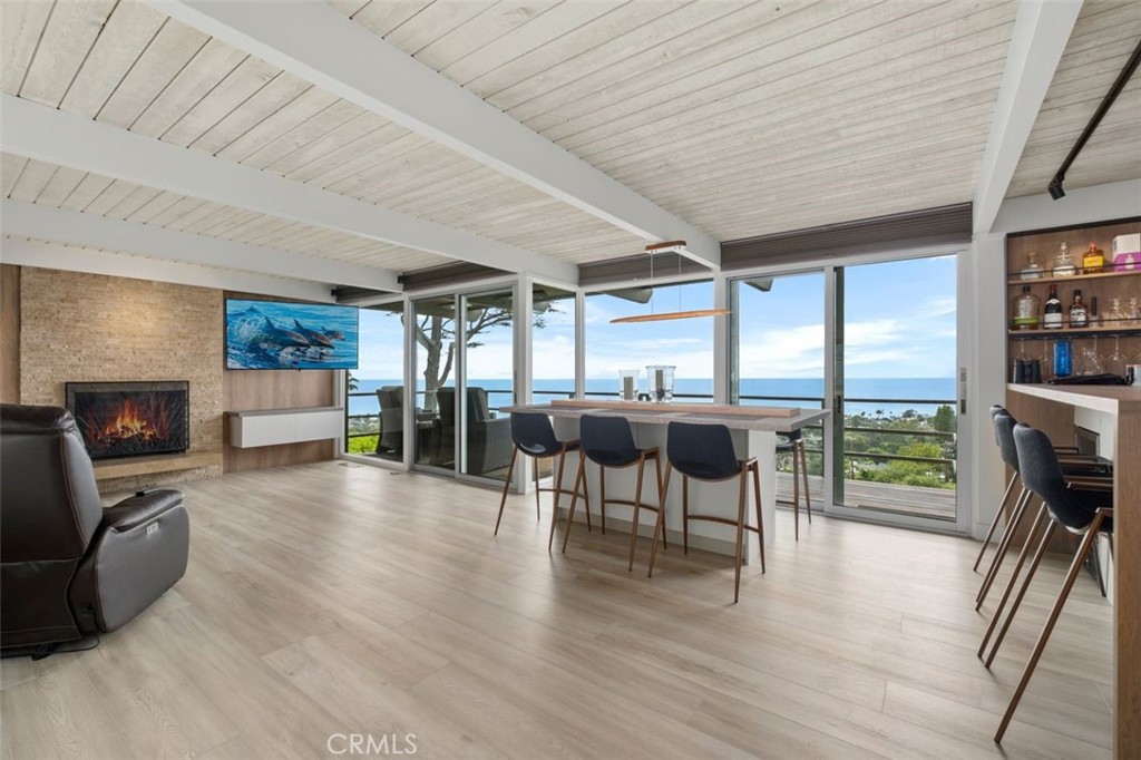 945 Coast View Drive Laguna Beach, CA 92651 - Photo 15 of 40 a view of a dining room with furniture window and wooden floor