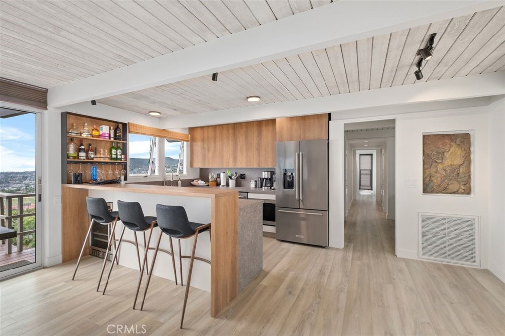 945 Coast View Drive Laguna Beach, CA 92651 - Photo 19 of 40 a kitchen with a table and chairs in it