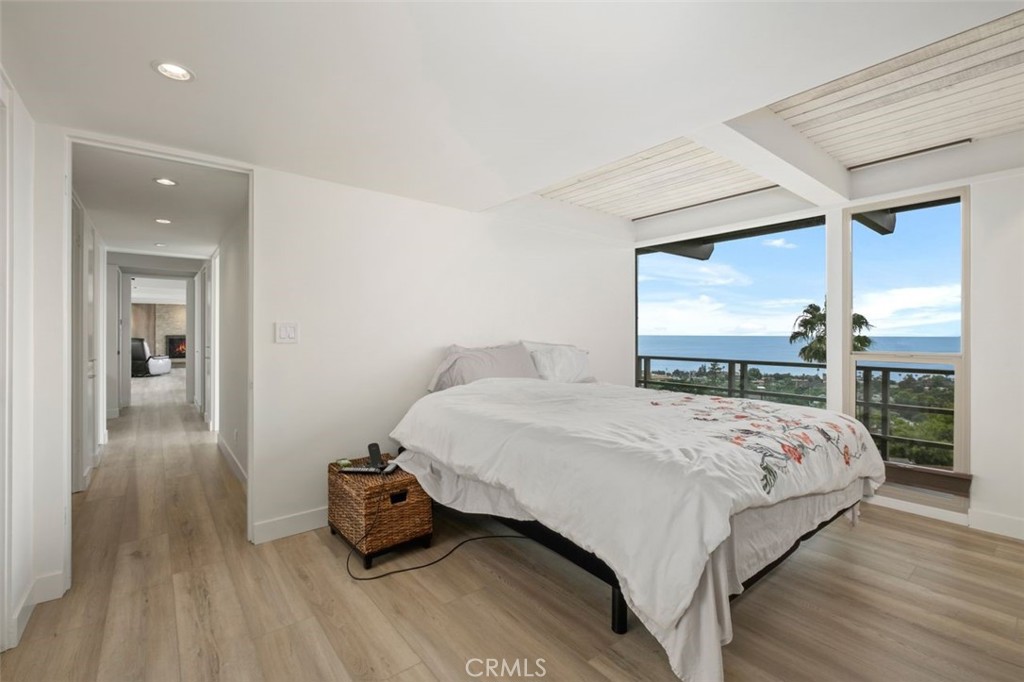 945 Coast View Drive Laguna Beach, CA 92651 - Photo 25 of 40 a bedroom with a bed and a large window
