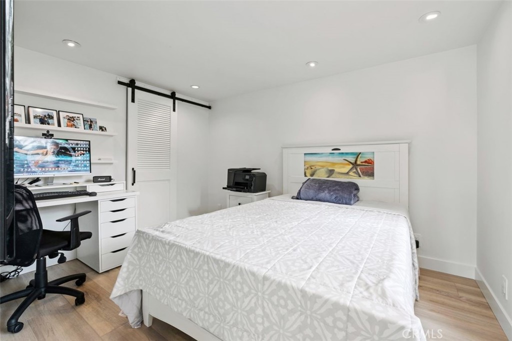 945 Coast View Drive Laguna Beach, CA 92651 - Photo 28 of 40 a bedroom with a bed and a desk