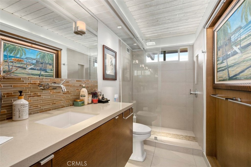 945 Coast View Drive Laguna Beach, CA 92651 - Photo 29 of 40 a bathroom with a sink a toilet and shower