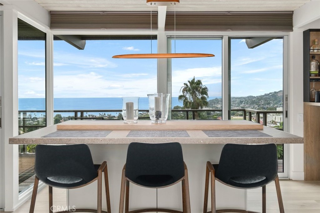 945 Coast View Drive Laguna Beach, CA 92651 - Photo 4 of 40 a kitchen with a window a sink and a refrigerator