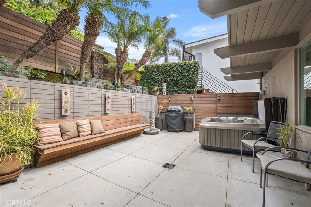 945 Coast View Drive Laguna Beach, CA 92651 - Photo 8 of 40 a view of a patio with couches table and chairs and potted plants