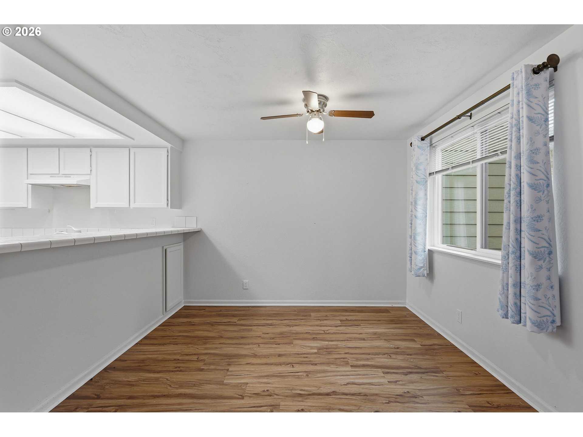 2001 Lake Isle Terrace Eugene, OR 97401 - Photo 11 of 36 a view of empty room with wooden floor and window