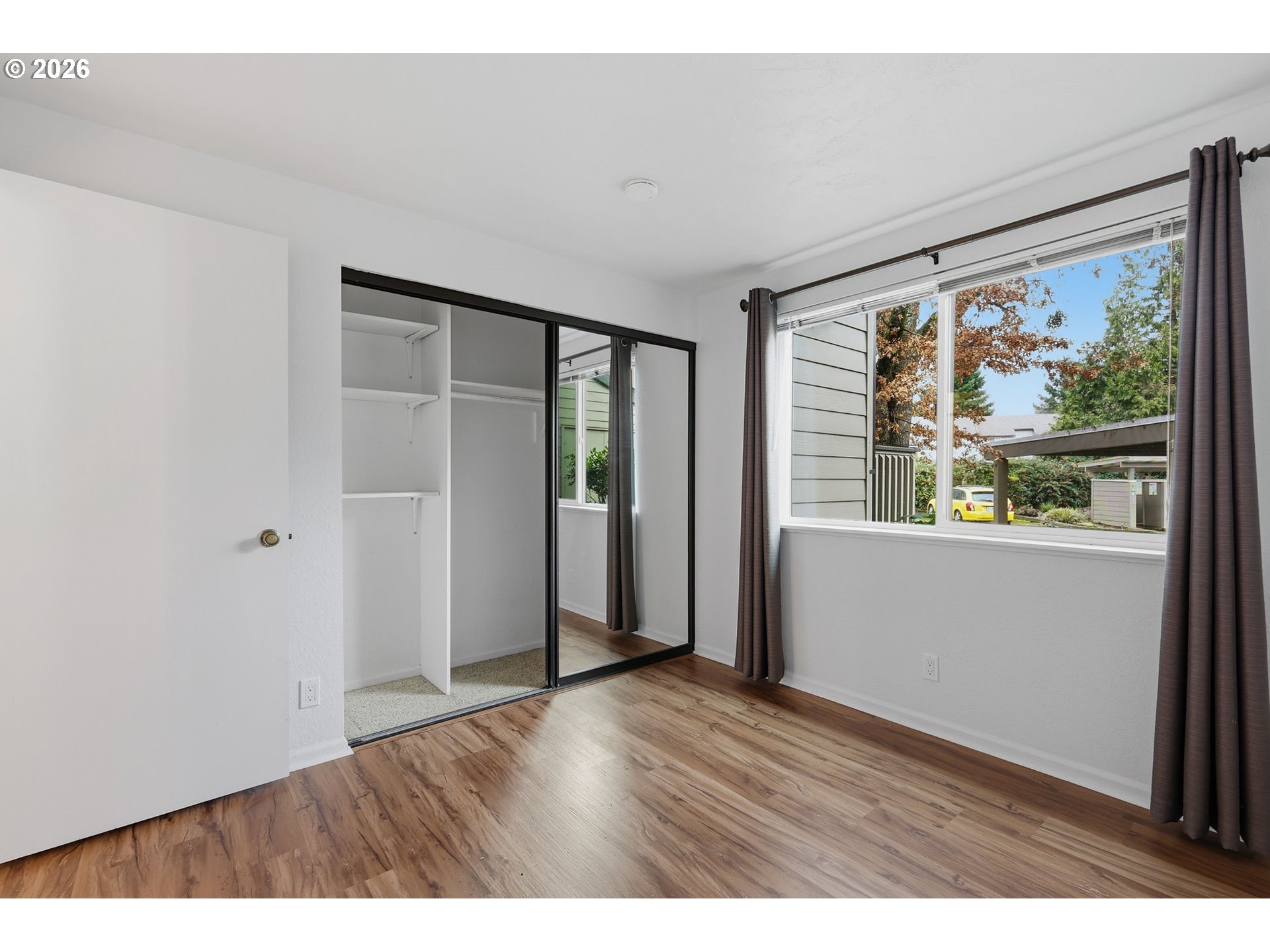 2001 Lake Isle Terrace Eugene, OR 97401 - Photo 17 of 36 a view of an empty room with wooden floor and a window