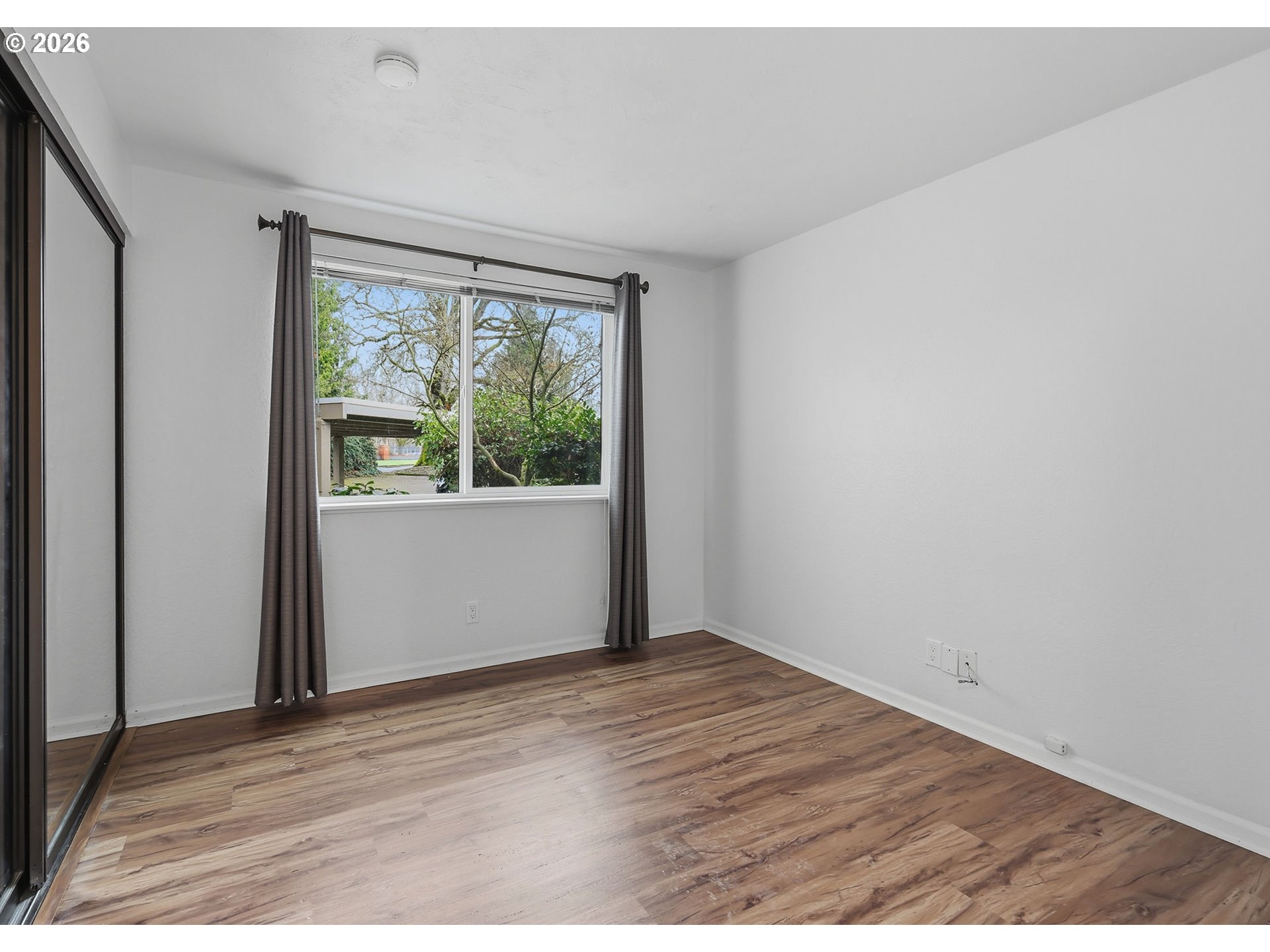 2001 Lake Isle Terrace Eugene, OR 97401 - Photo 18 of 36 an empty room with wooden floor and windows