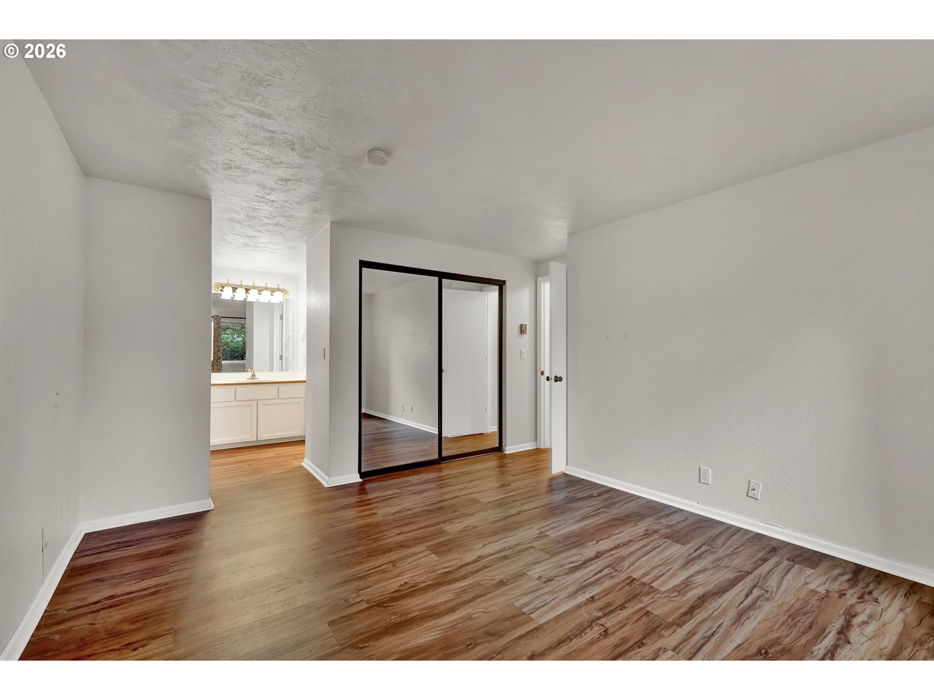 2001 Lake Isle Terrace Eugene, OR 97401 - Photo 19 of 36 a view of an empty room with wooden floor