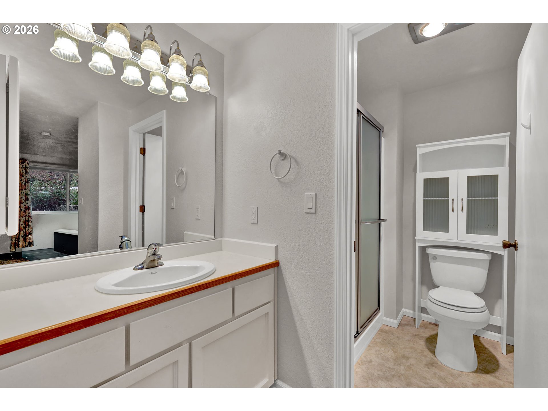 2001 Lake Isle Terrace Eugene, OR 97401 - Photo 21 of 36 a bathroom with a sink a toilet and a mirror