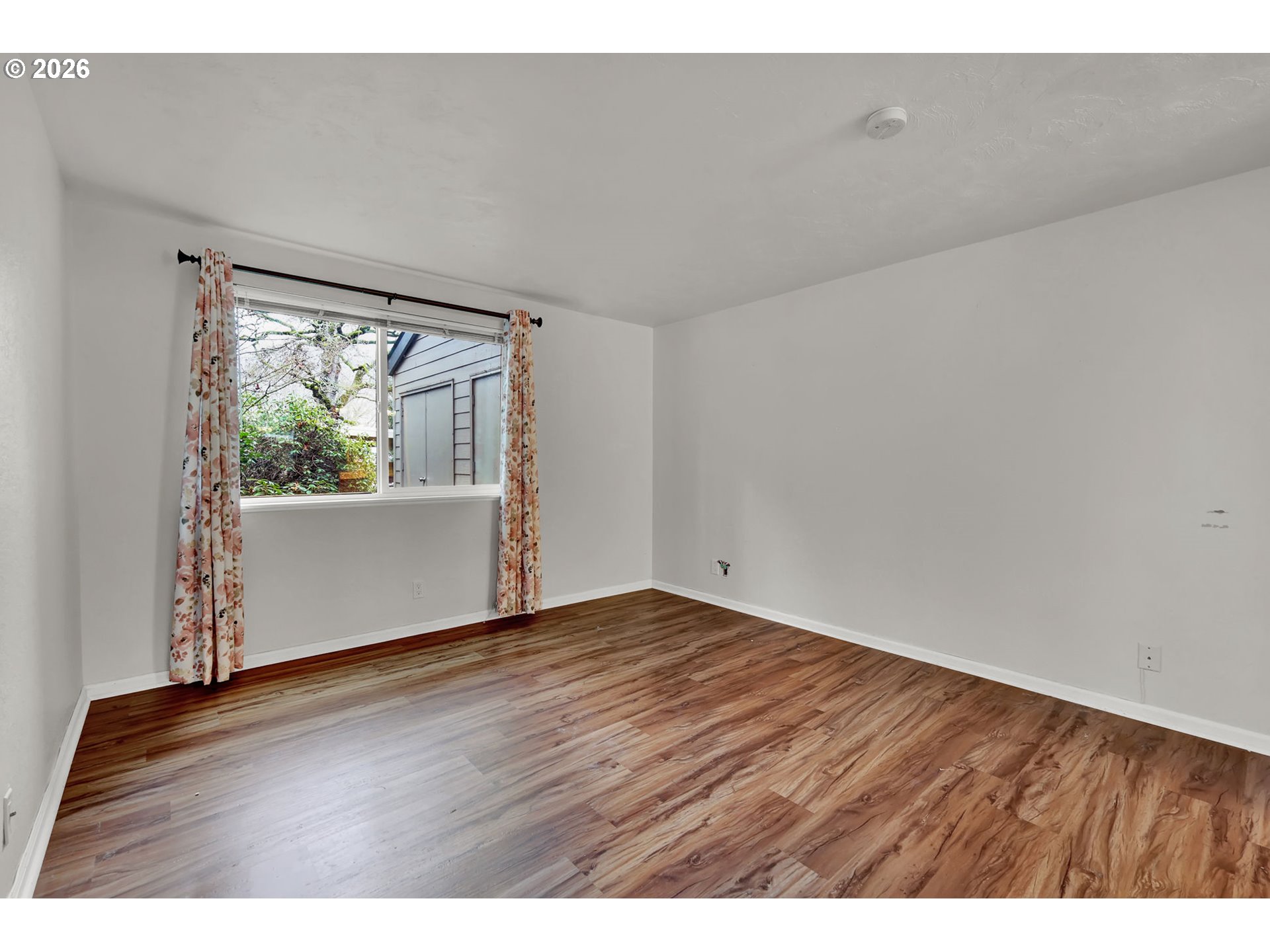 2001 Lake Isle Terrace Eugene, OR 97401 - Photo 23 of 36 a view of an empty room with wooden floor and a window