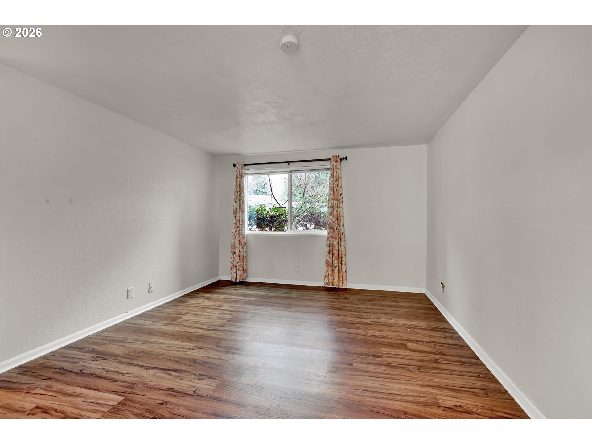 2001 Lake Isle Terrace Eugene, OR 97401 - Photo 24 of 36 a view of an empty room with wooden floor and a window