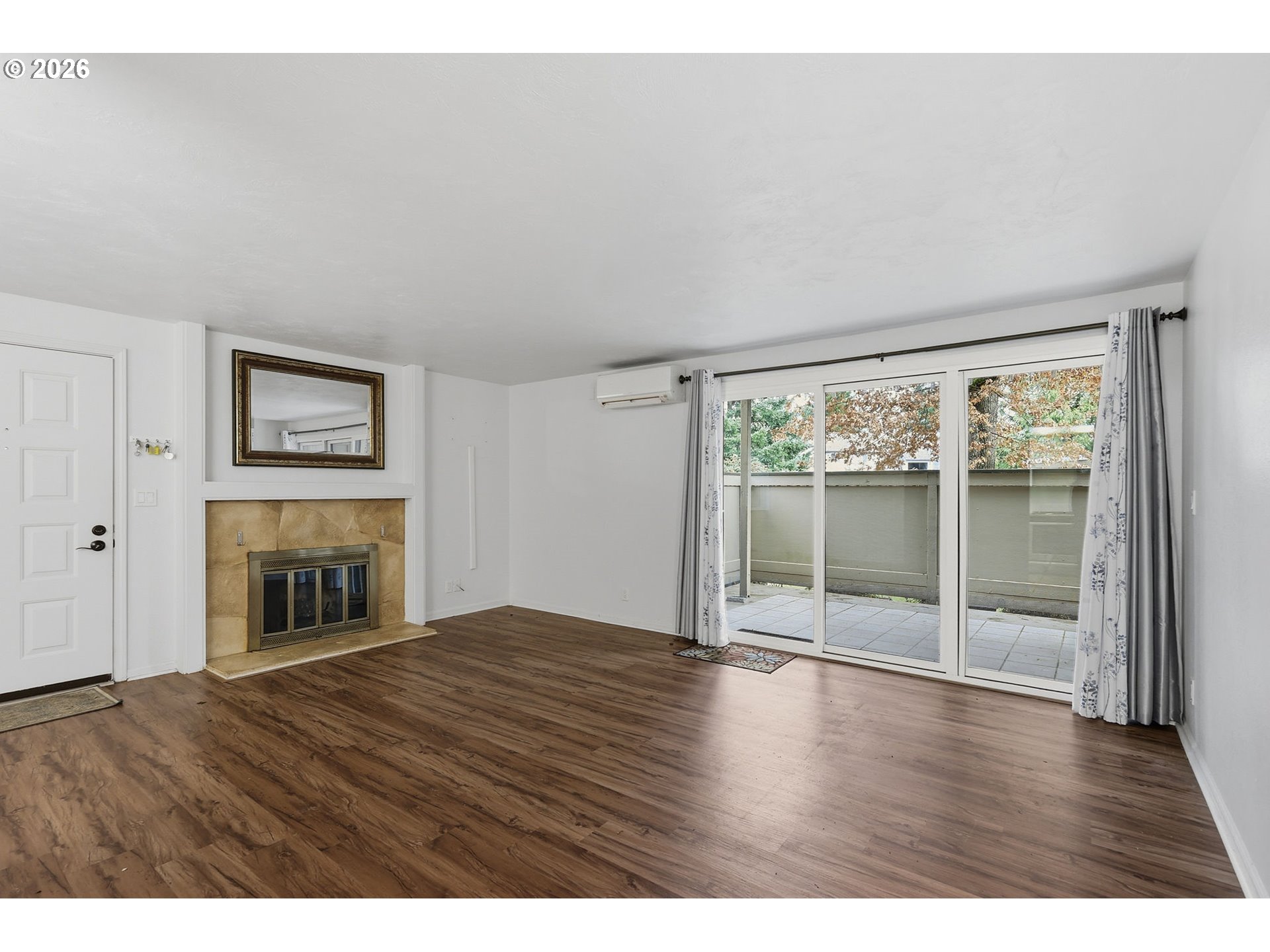 2001 Lake Isle Terrace Eugene, OR 97401 - Photo 6 of 36 an empty room with wooden floor fireplace and windows