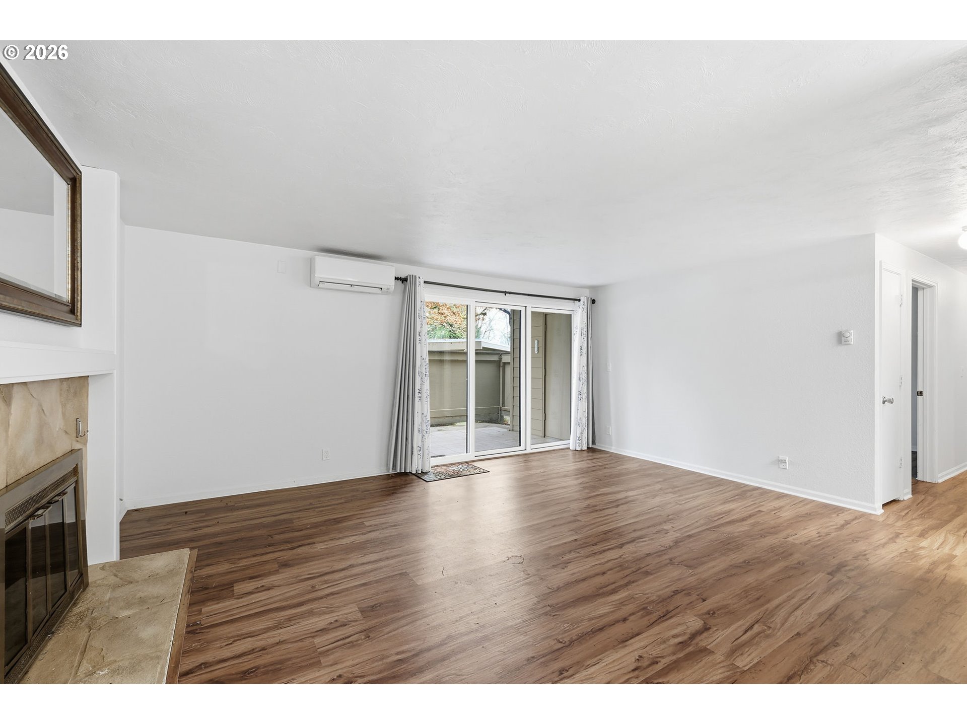 2001 Lake Isle Terrace Eugene, OR 97401 - Photo 7 of 36 a view of an empty room with wooden floor and a window