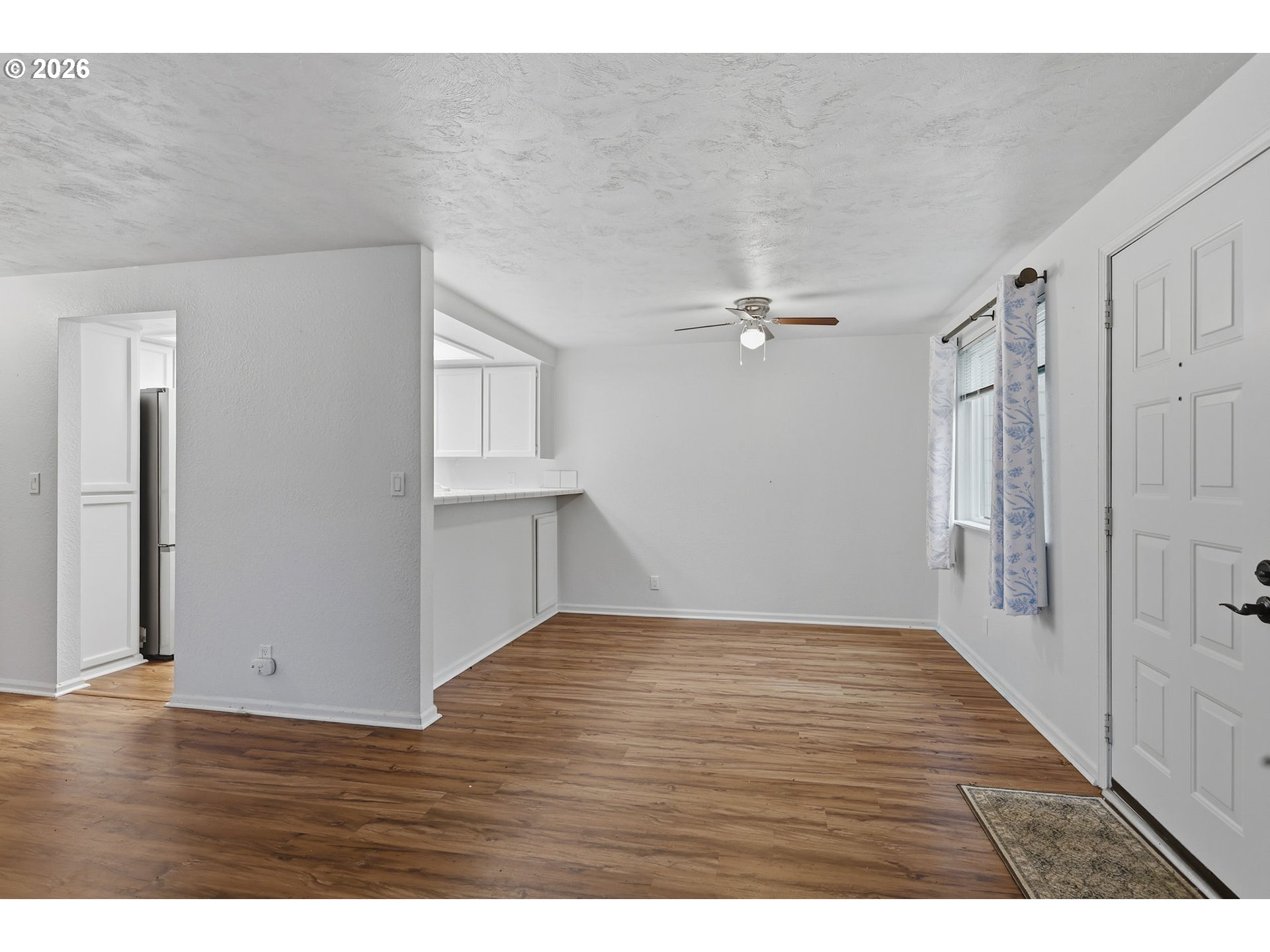 2001 Lake Isle Terrace Eugene, OR 97401 - Photo 10 of 36 a view of an empty room with wooden floor and a window