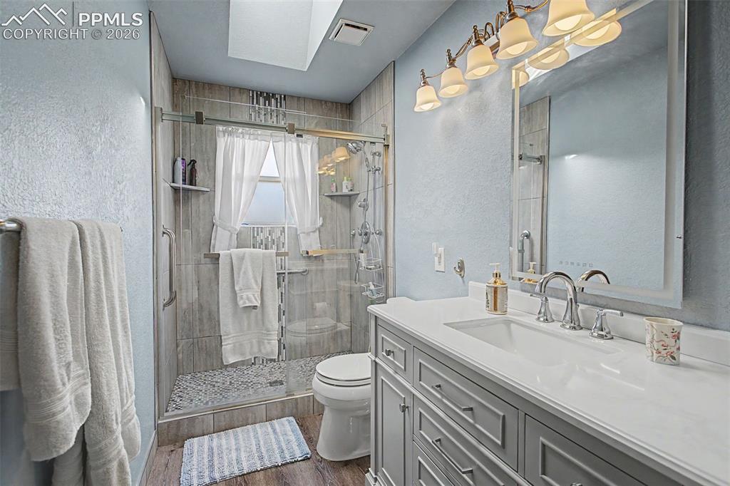 2345 Ramsgate Terrace Colorado Springs, CO 80919 - Photo 32 of 46 Upper level 3/4 bathroom, with skylight and floor-to-ceiling tiled walk-in shower.