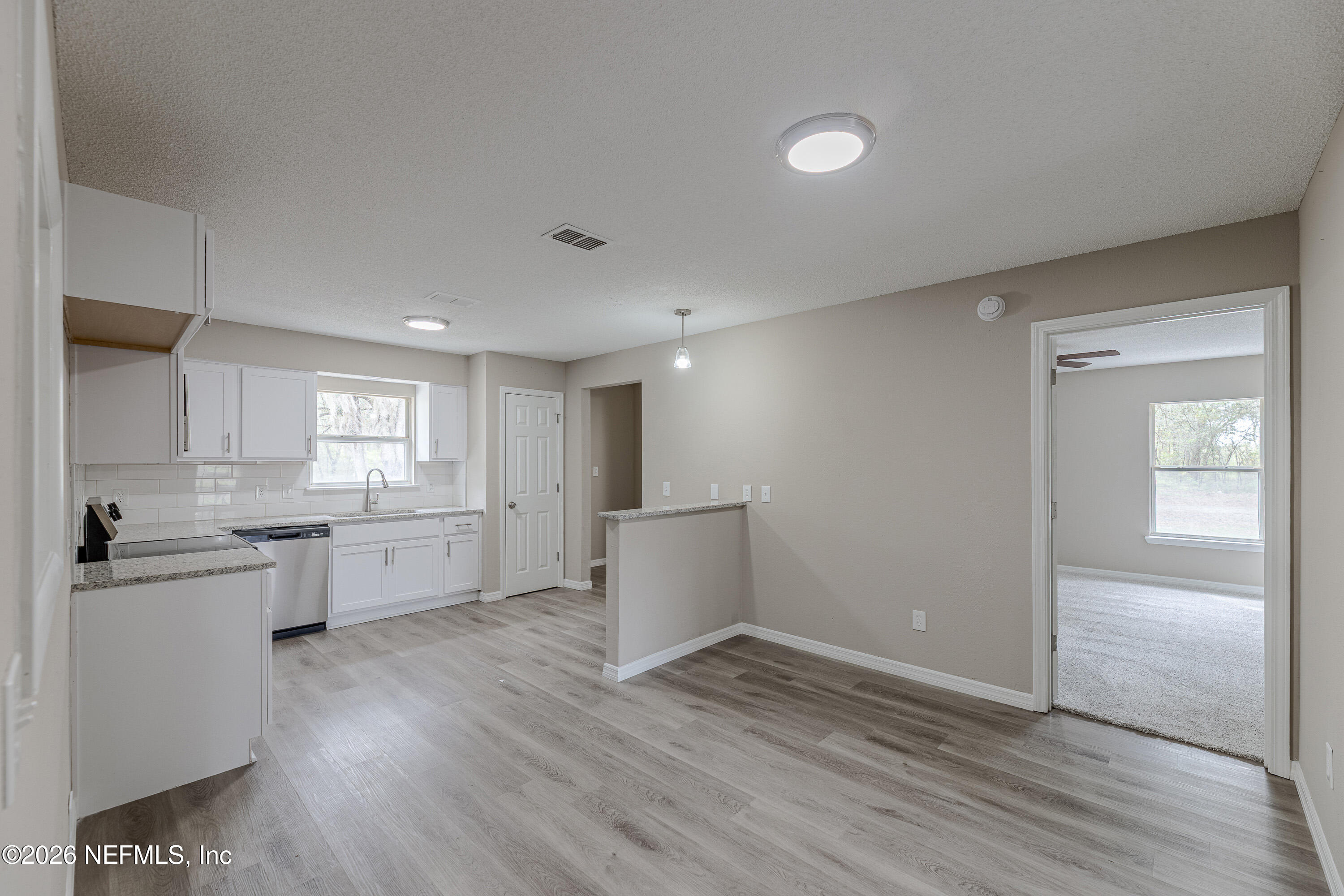 67104 Elnora Lane Yulee, FL 32097 - Photo 14 of 39 a view of kitchen with wooden floor and electronic appliances