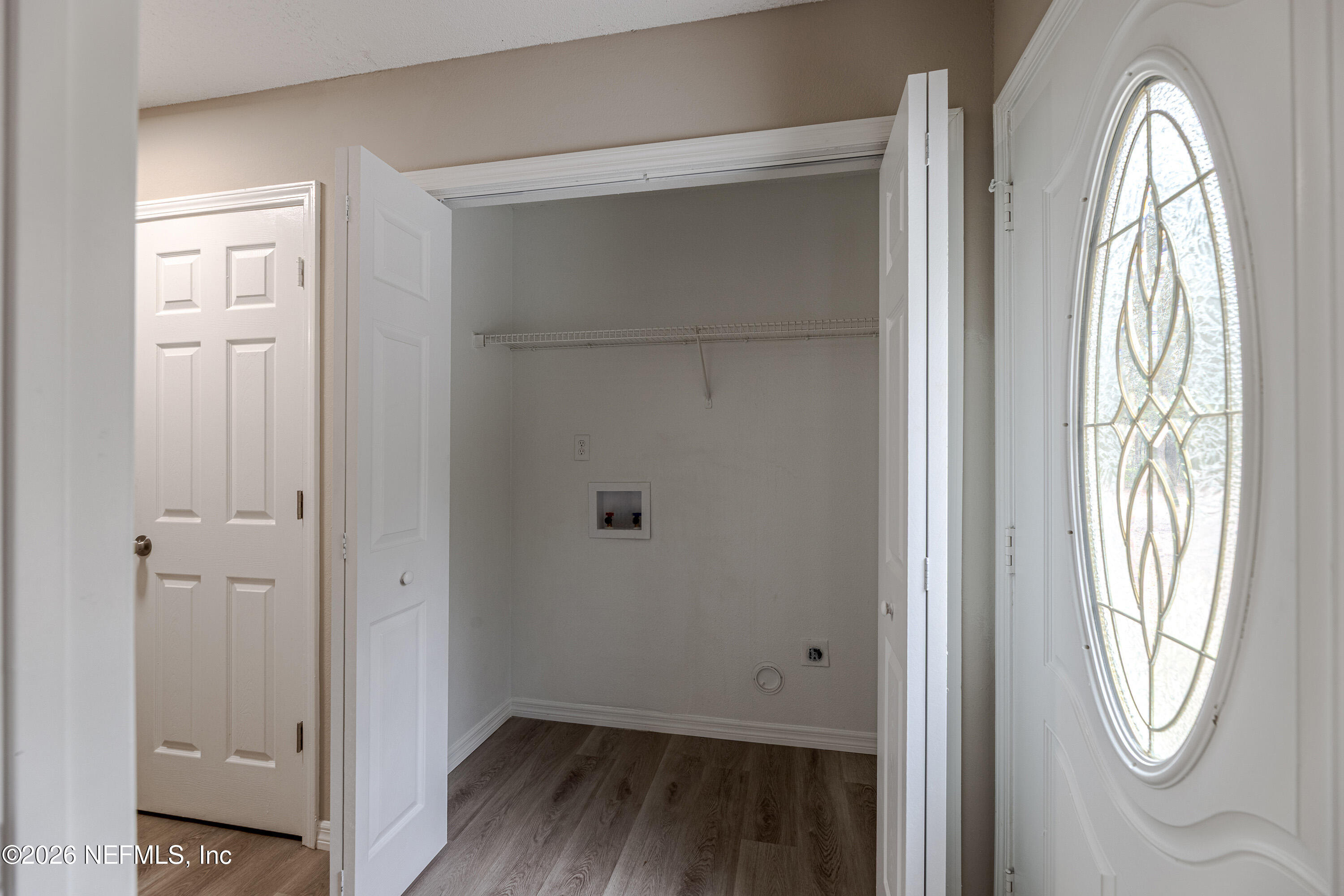 67104 Elnora Lane Yulee, FL 32097 - Photo 16 of 39 a view of empty room with wooden floor and fan