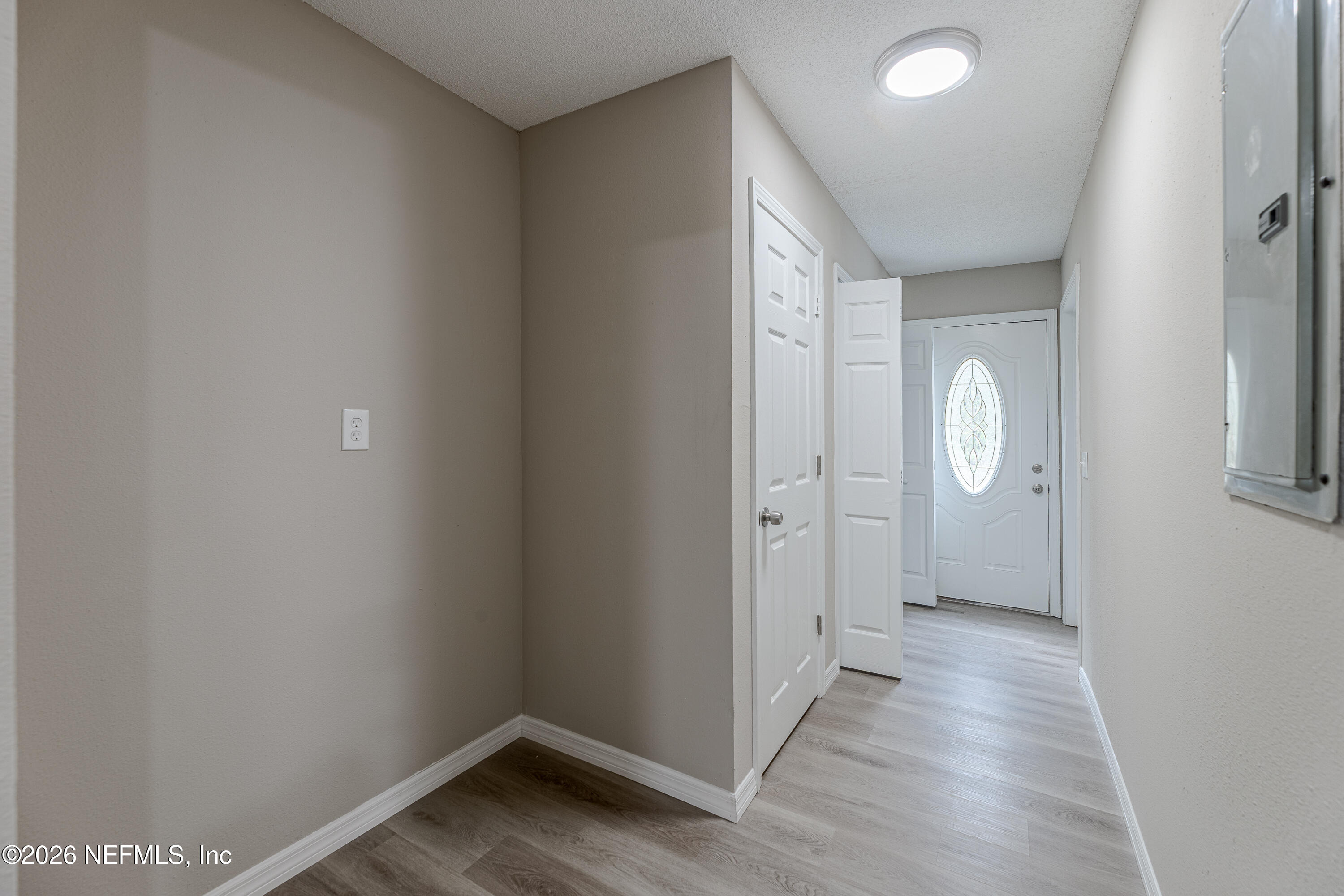 67104 Elnora Lane Yulee, FL 32097 - Photo 17 of 39 an empty room with wooden floor and mirror