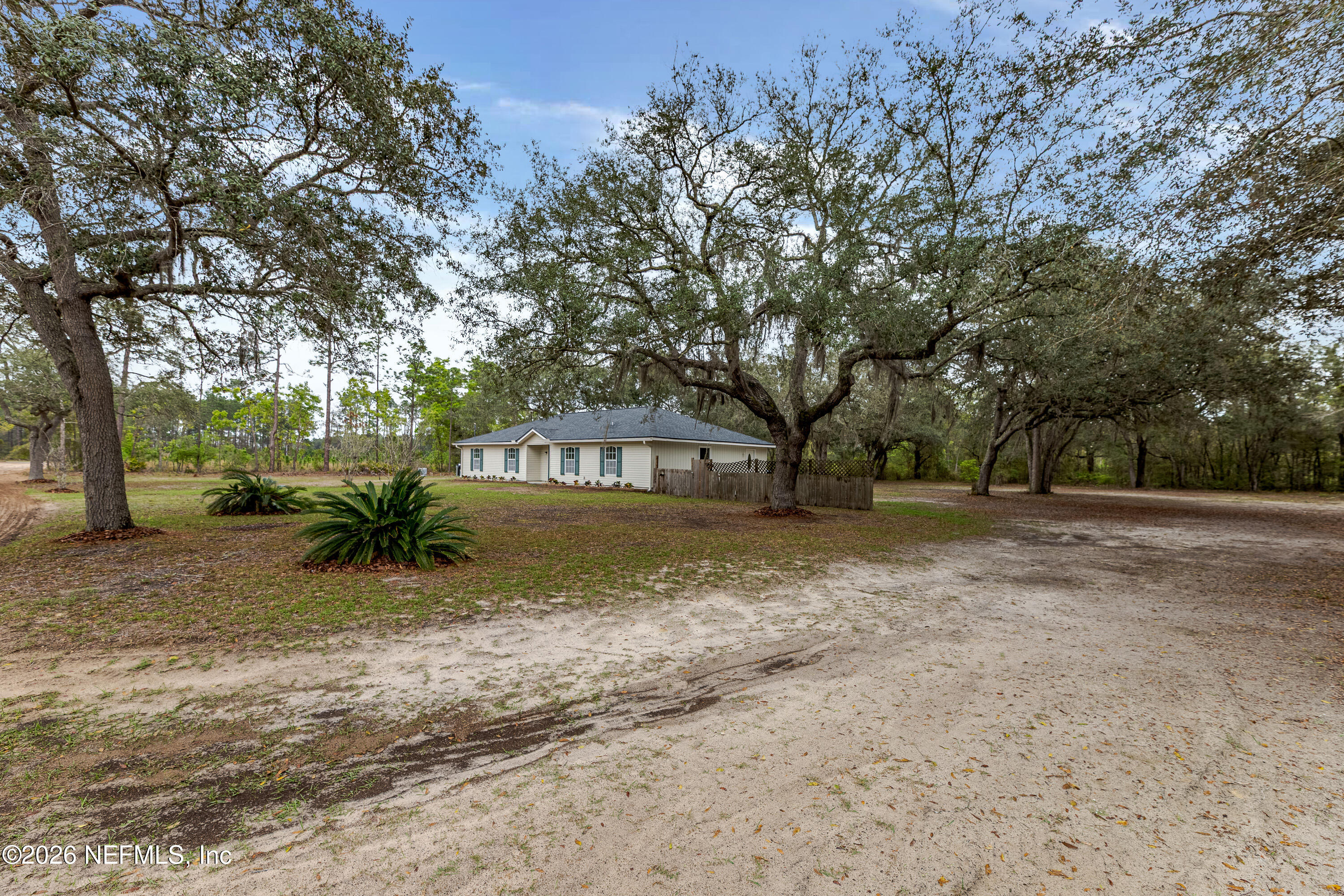 67104 Elnora Lane Yulee, FL 32097 - Photo 2 of 39 a view of a yard with plants and trees