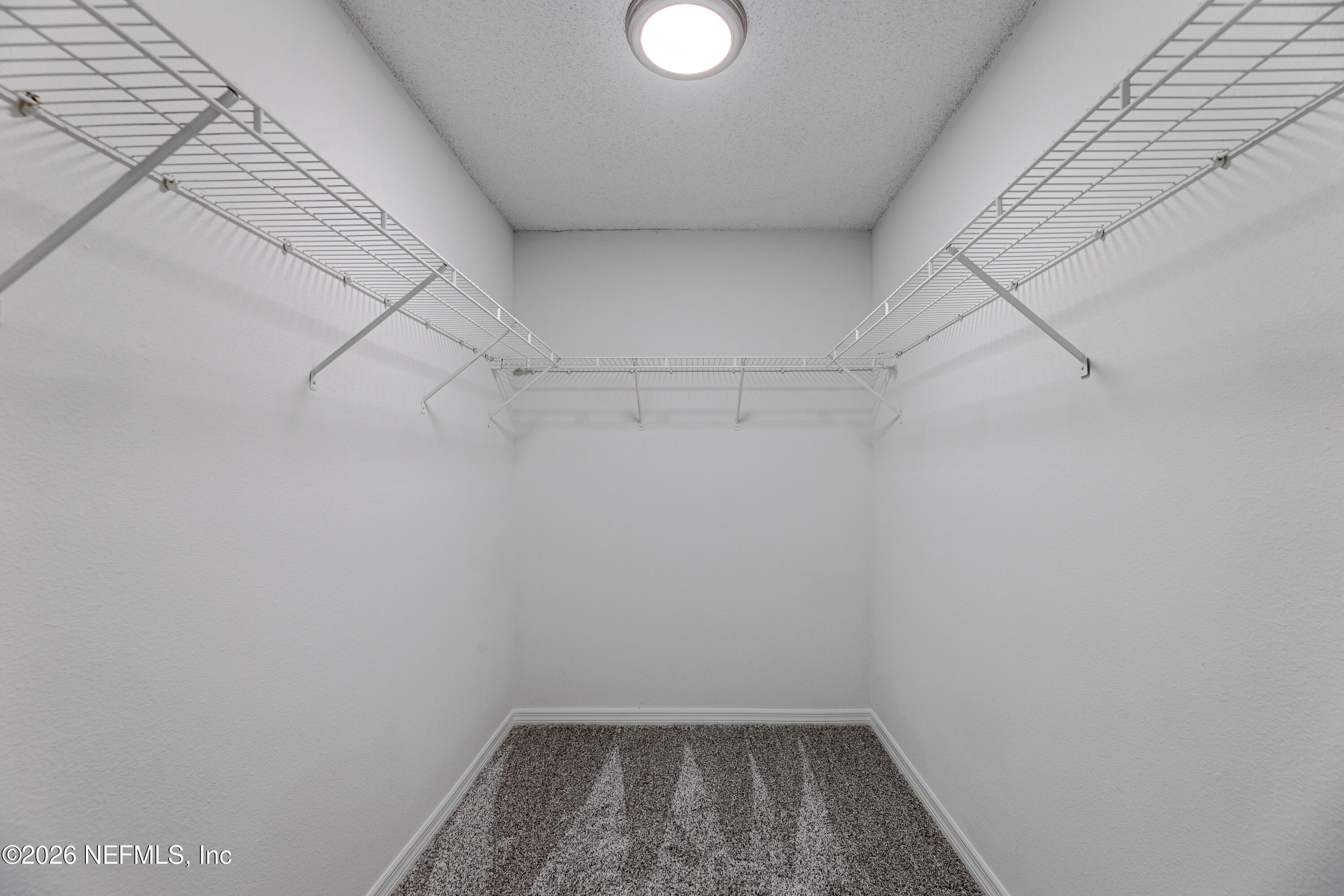 67104 Elnora Lane Yulee, FL 32097 - Photo 22 of 39 a view of a room with racks on the wall