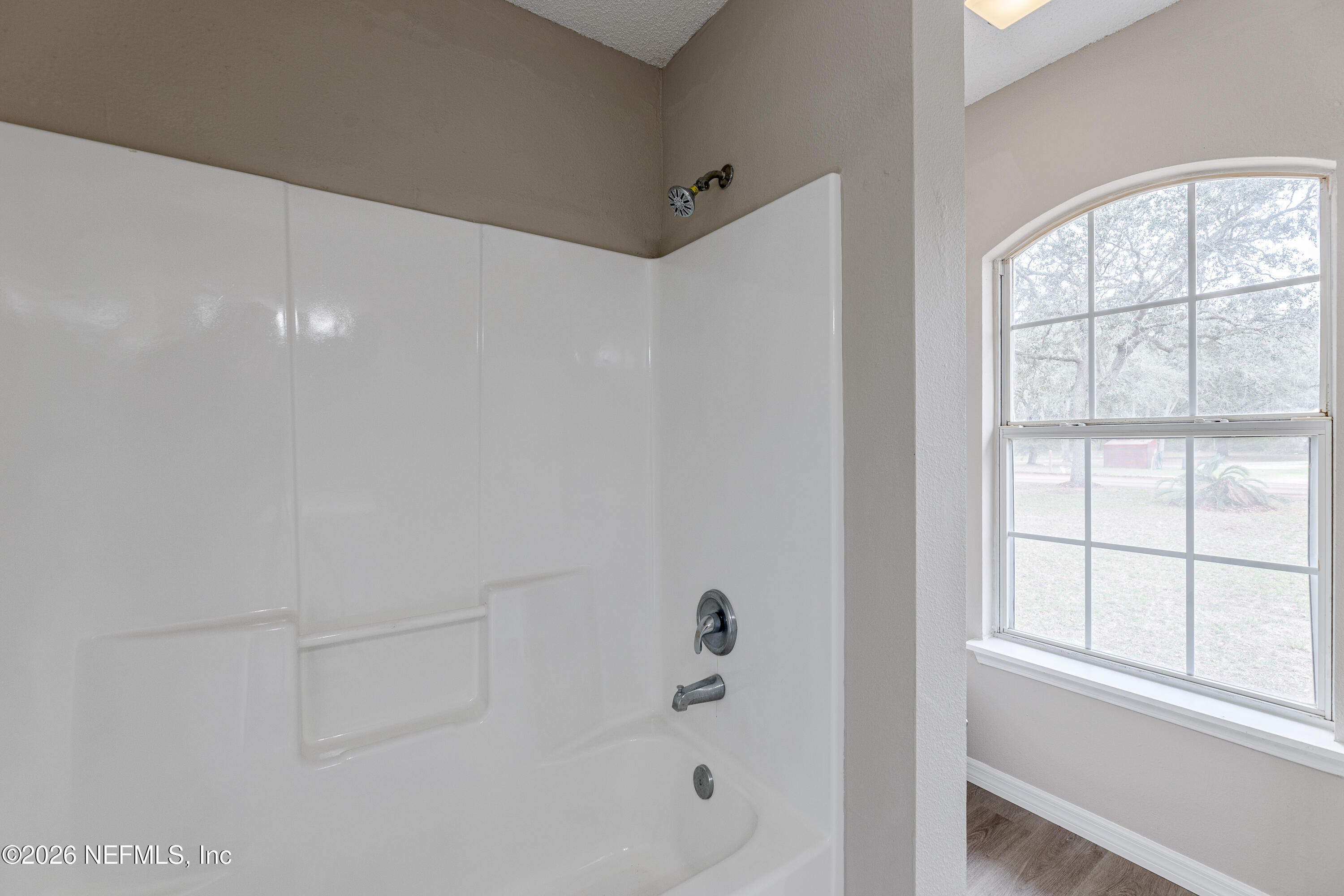 67104 Elnora Lane Yulee, FL 32097 - Photo 24 of 39 a bathroom with a bathtub and window