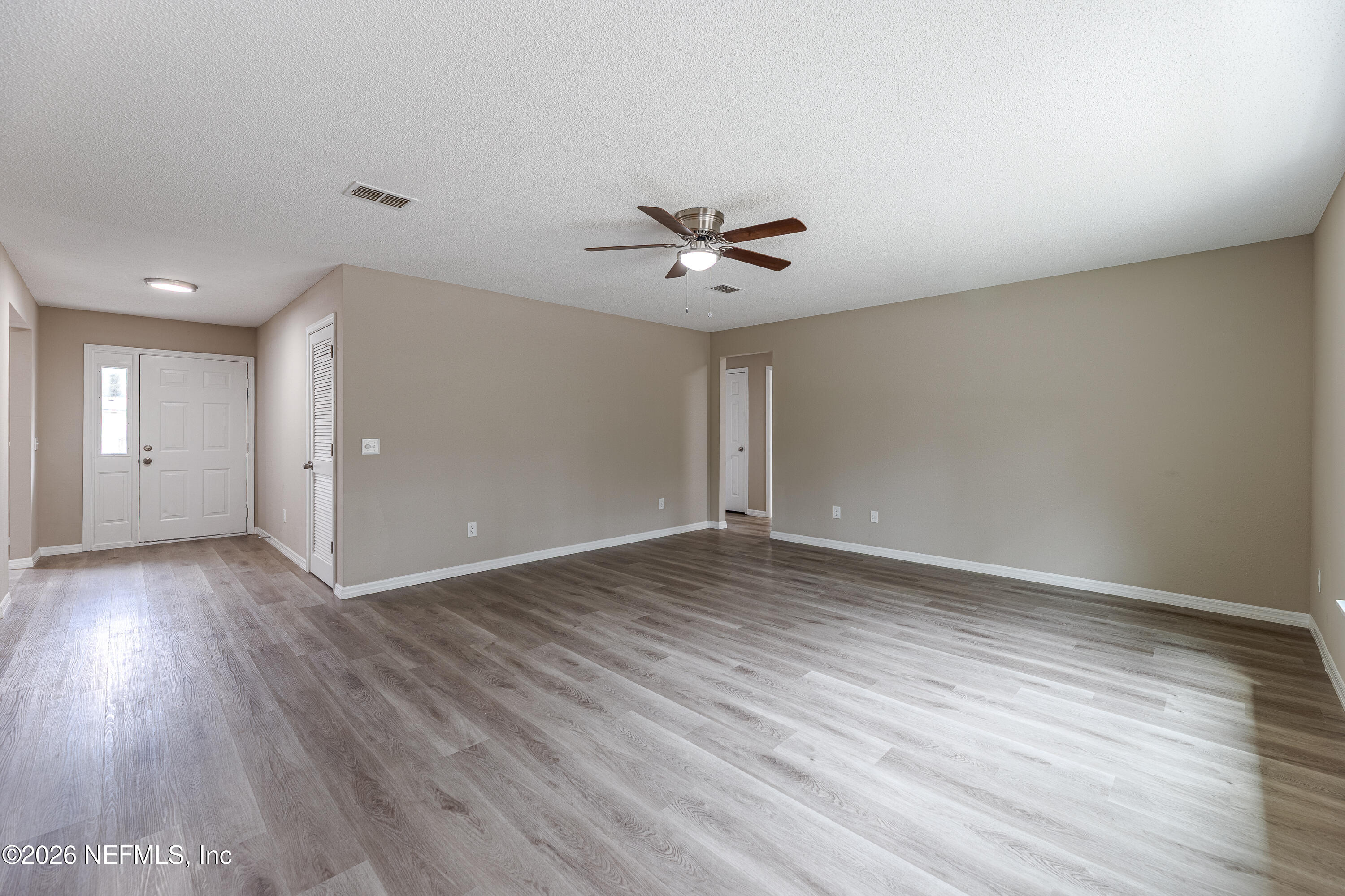 67104 Elnora Lane Yulee, FL 32097 - Photo 27 of 39 wooden floor in an empty room with a window