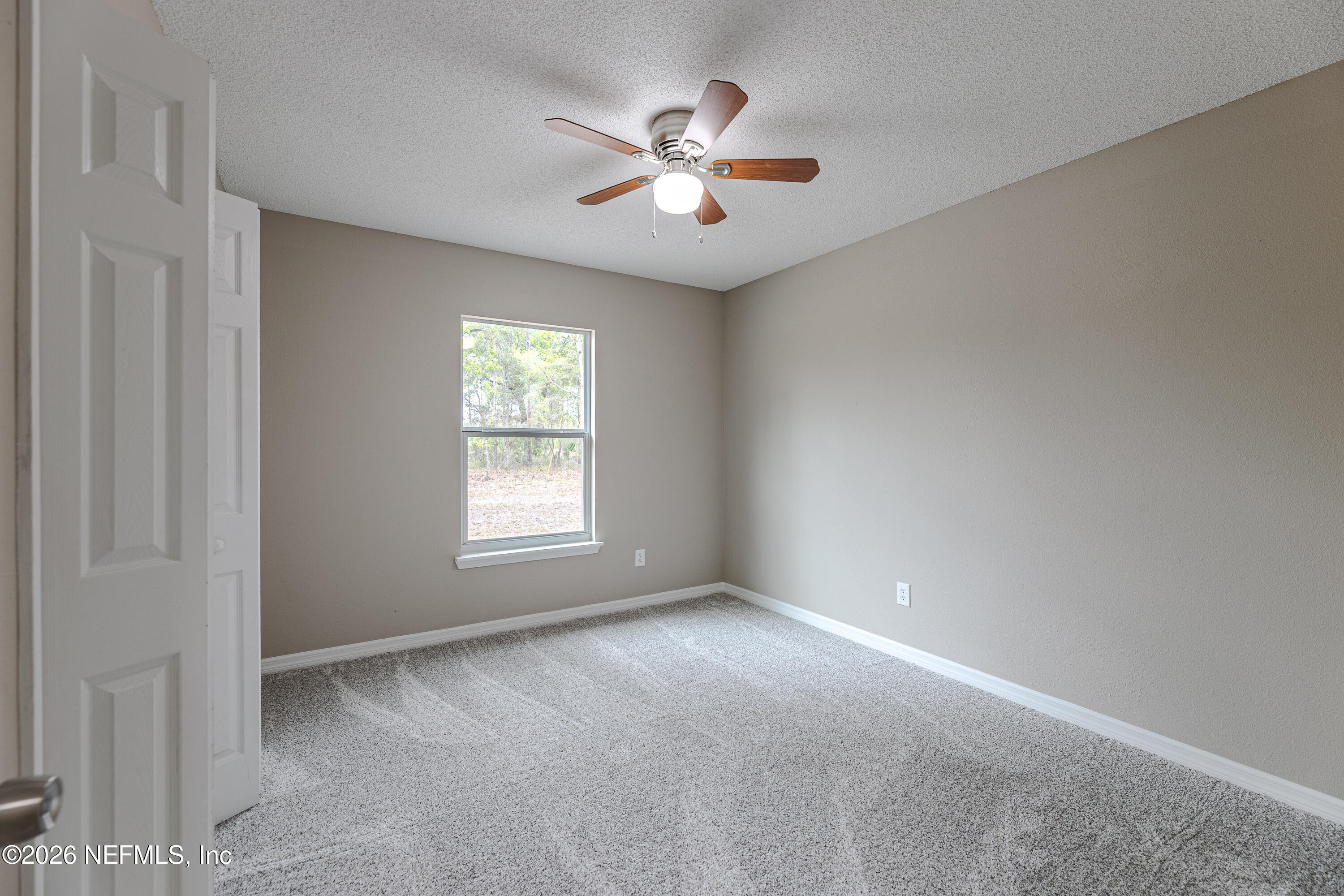 67104 Elnora Lane Yulee, FL 32097 - Photo 36 of 39 a view of a livingroom with a ceiling fan and window