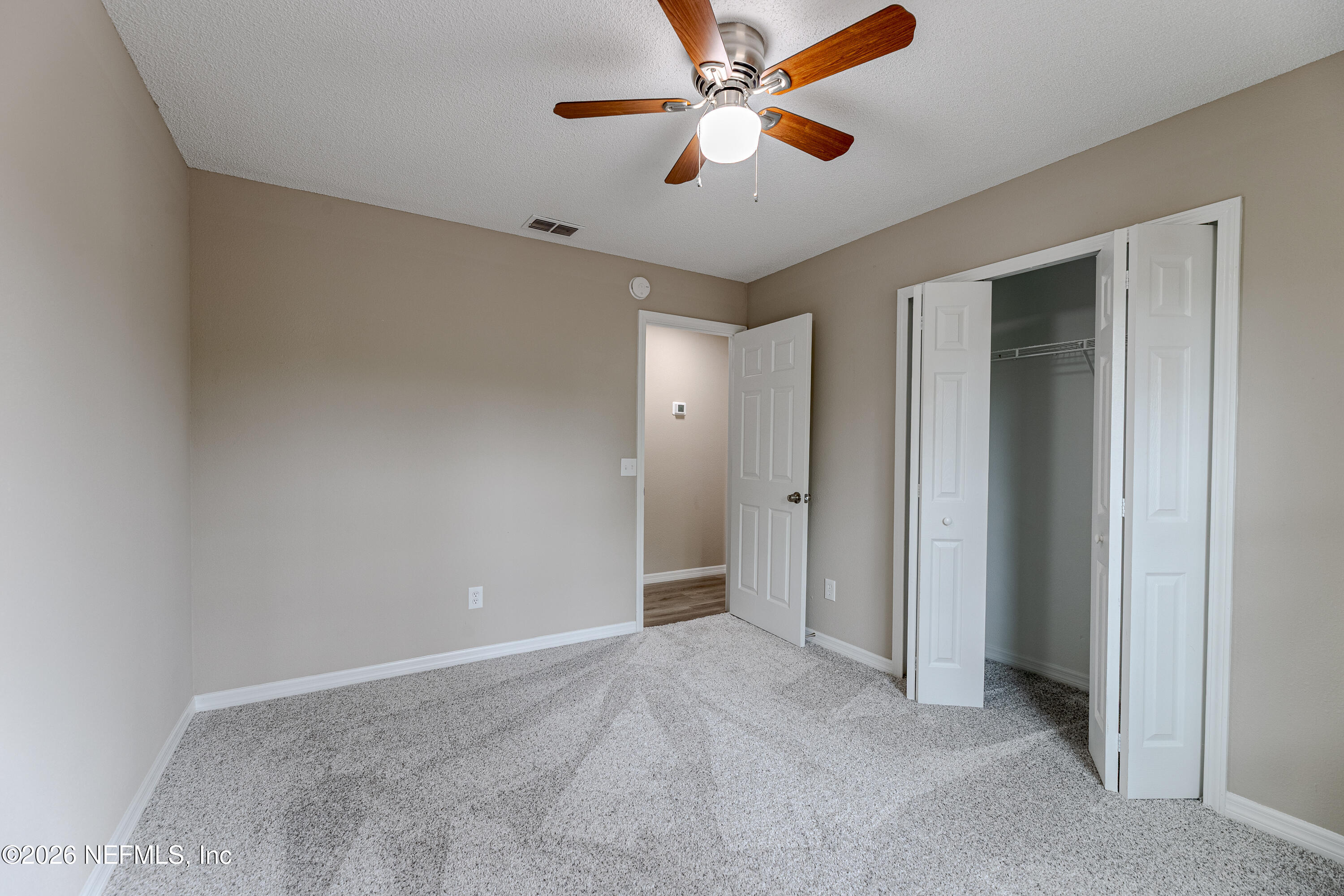 67104 Elnora Lane Yulee, FL 32097 - Photo 37 of 39 a view of empty room with a ceiling fan
