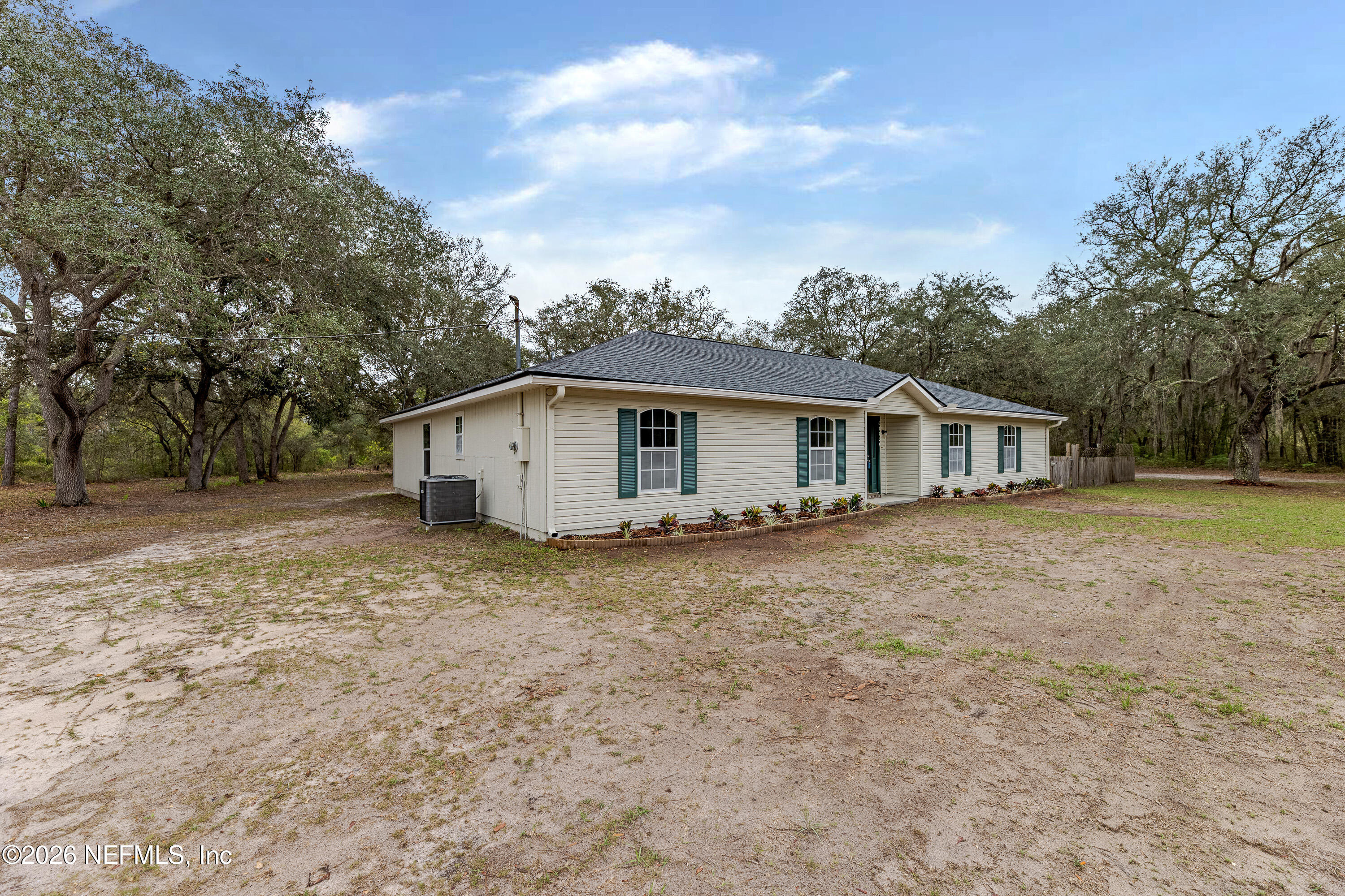 67104 Elnora Lane Yulee, FL 32097 - Photo 4 of 39 front view of house with a yard