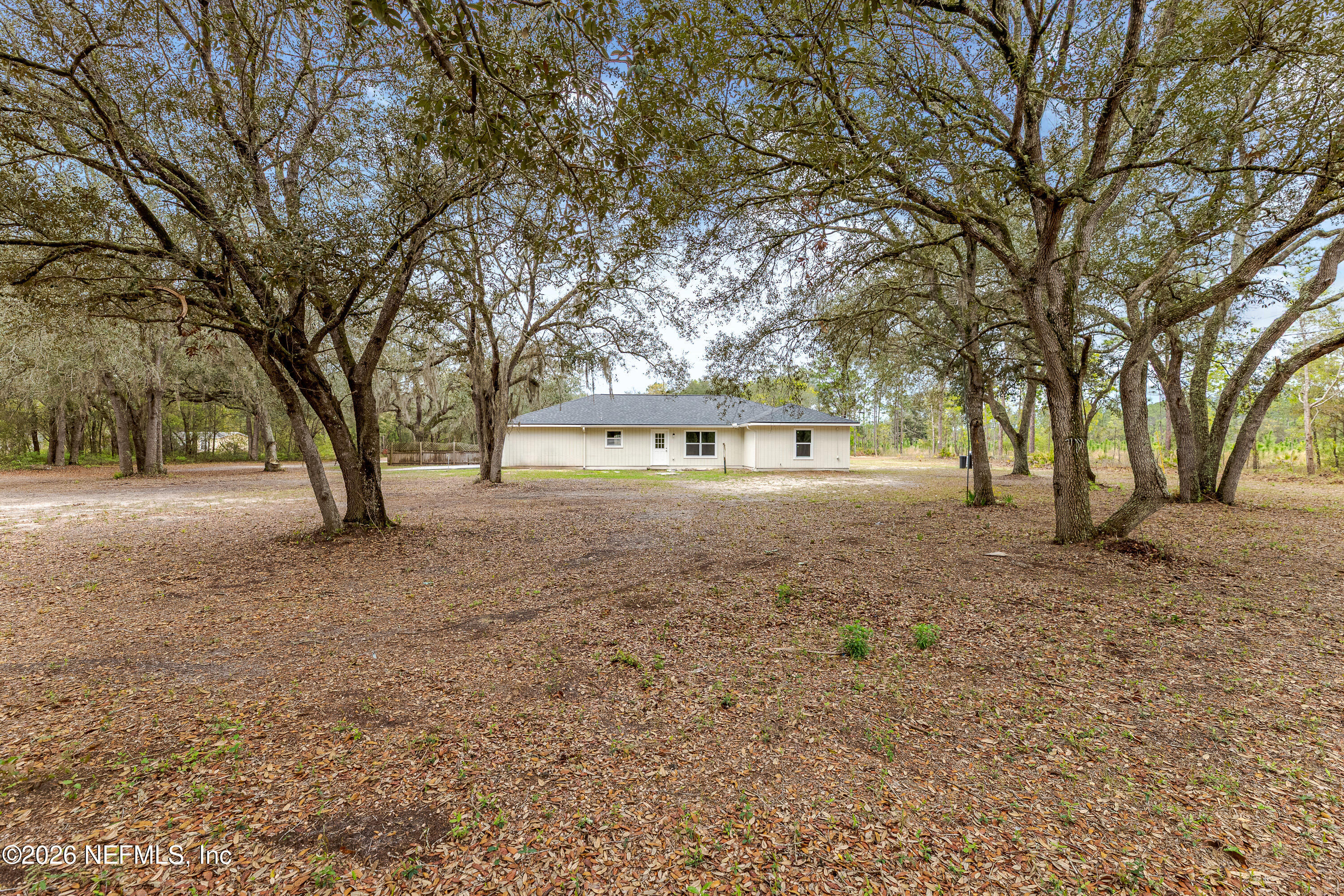 67104 Elnora Lane Yulee, FL 32097 - Photo 6 of 39 a view of house with trees in the background