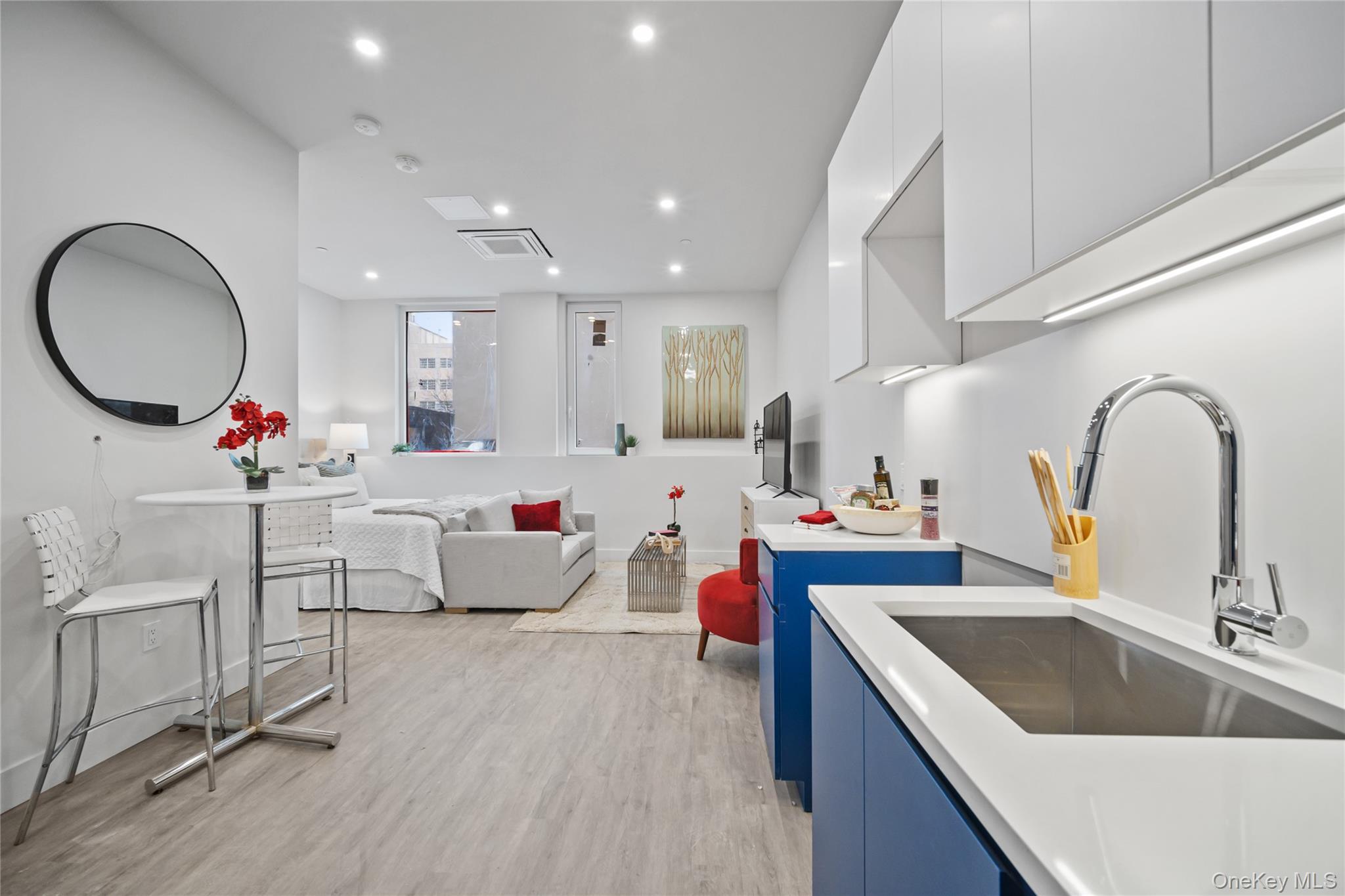 a kitchen with sink refrigerator and cabinets