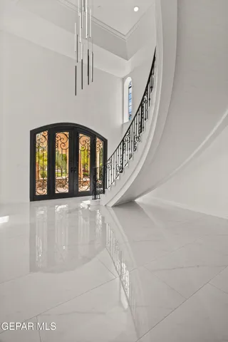 a view of an empty room with a window and a kitchen