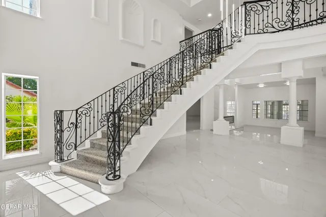 a large bedroom with a large bed and a large window