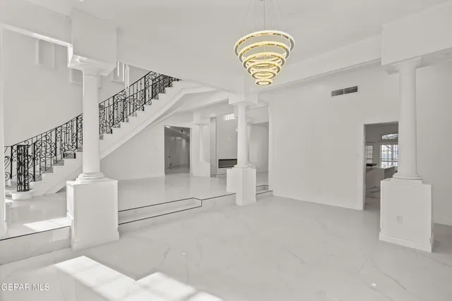 a view of an empty room with a fireplace and a window