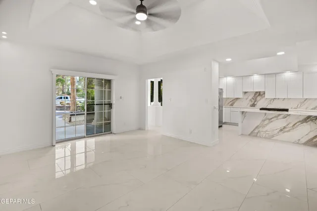 a view of a house with a big yard and large trees