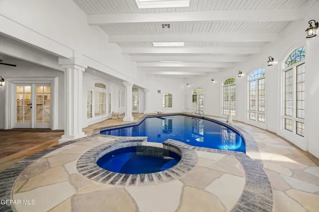 an aerial view of a house with swimming pool and big yard