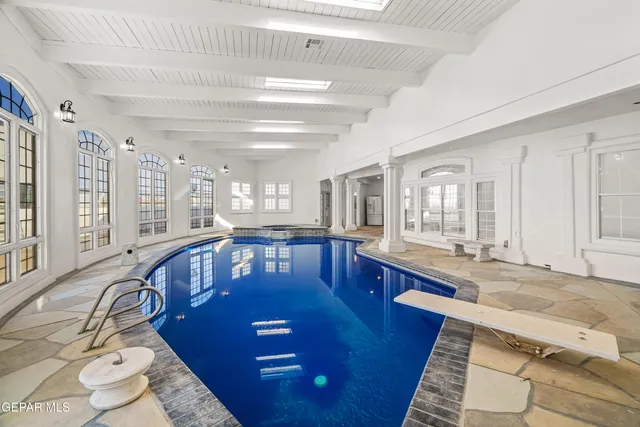 an aerial view of ocean and residential houses with outdoor space