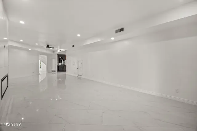 an aerial view of ocean and residential houses with outdoor space