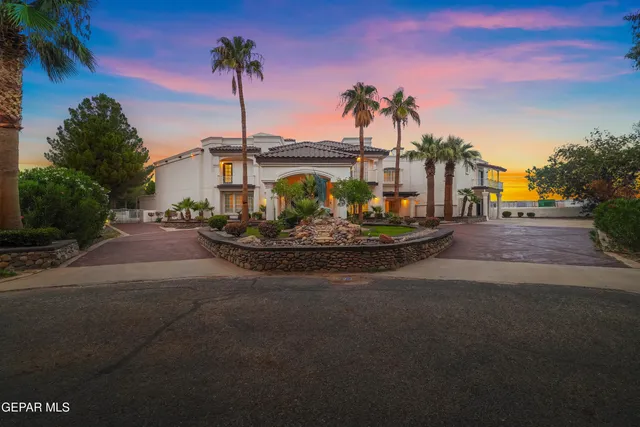 a kitchen that has a sink a stove and chairs