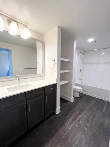 a spacious bathroom with stainless steel appliances sink and mirror