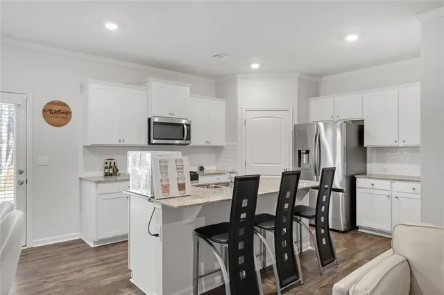 a kitchen with stainless steel appliances a refrigerator stove microwave and cabinets