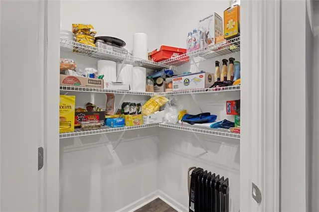 a utility room with lots of clutter and cabinets