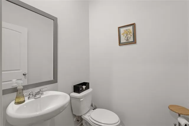 a white toilet sitting next to a white sink